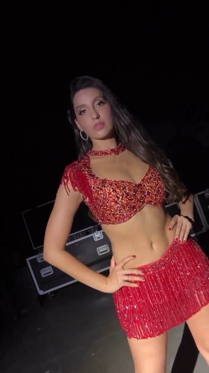 nora fatehi red outfit navel legs tour
