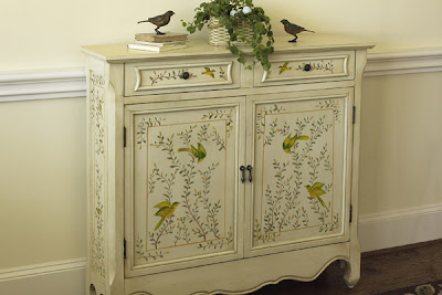 cabinet painted with birds in trees