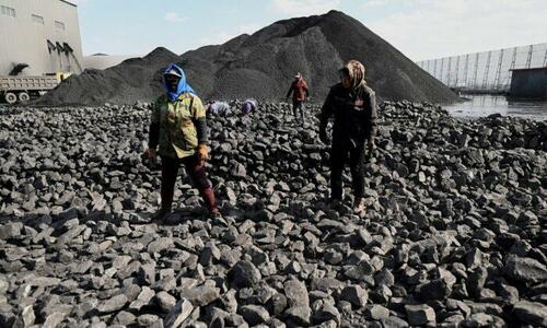 Workers sort coal near a coal mine in Datong, China's northern Shanxi Province on Nov. 3, 2021.