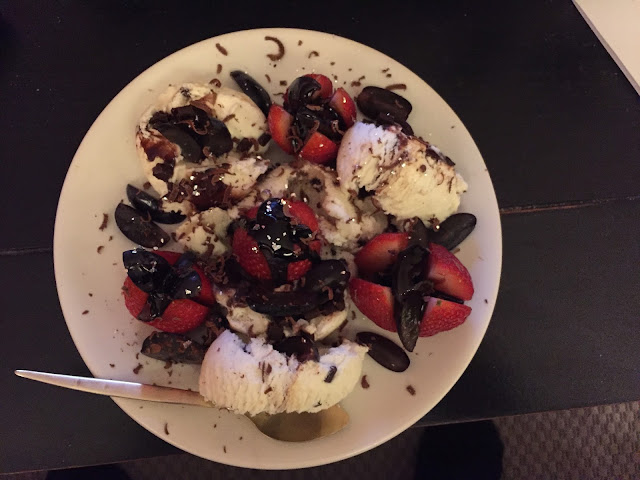 Dessert with strawberries, grapes, chocolate and ice-cream