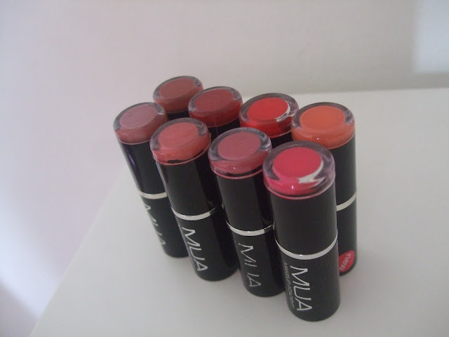 8 black packaged lipsticks lined up in rows of 4