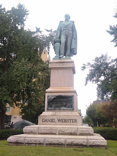 statue of man with coat around shoulders