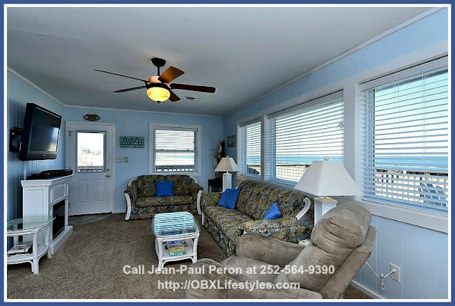 Natural light bathes the living room of this lovely oceanfront Outer Banks NC home for sale and gives it a light and airy ambience.