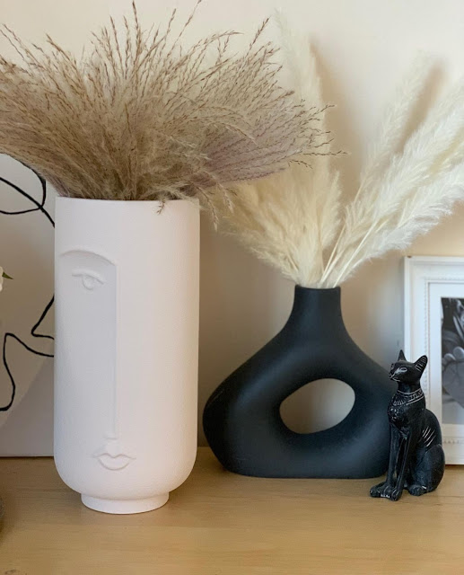 black donut vase with modern face vase