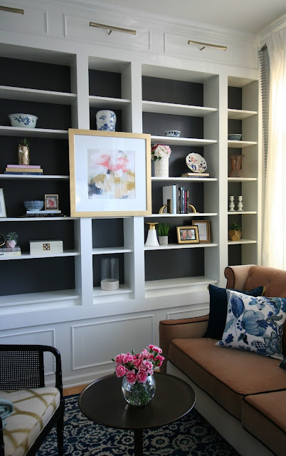 Living Room makeover with custom Ikea Billy bookcase built ins, blush velvet sofa, sherwin williams peppercorn on bookcase, sheriwin williams crushed ice on wall chic living room with picture lights