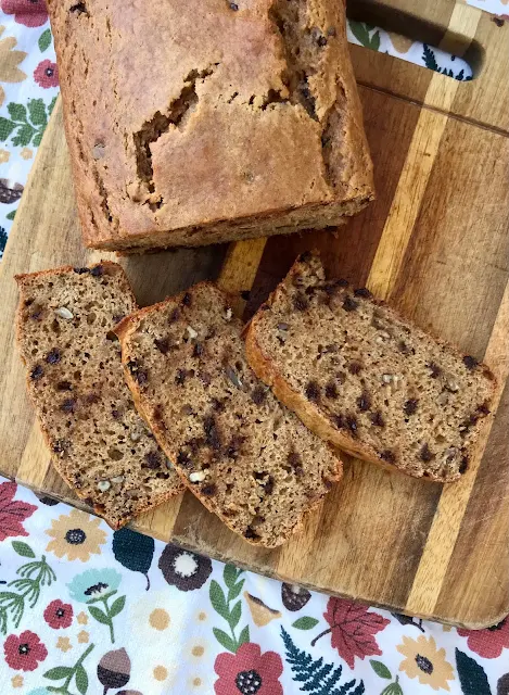 Loaf of chocolate chip pumpkin bread with slices cut.