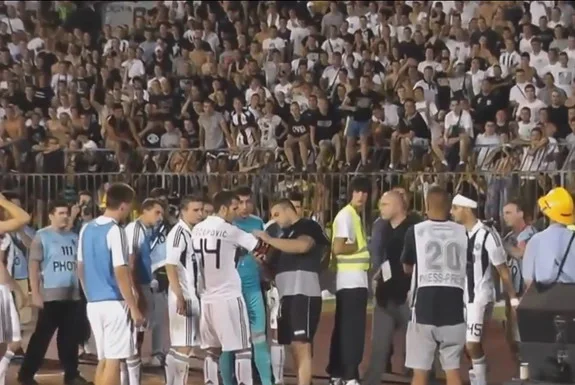 A Partizan Ultras leader Miloš Radisavljević Kimi removes the captain armband off Marko Šćepović