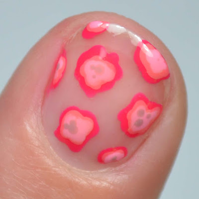 pink blobs of nail polish creating abstract floral nail art