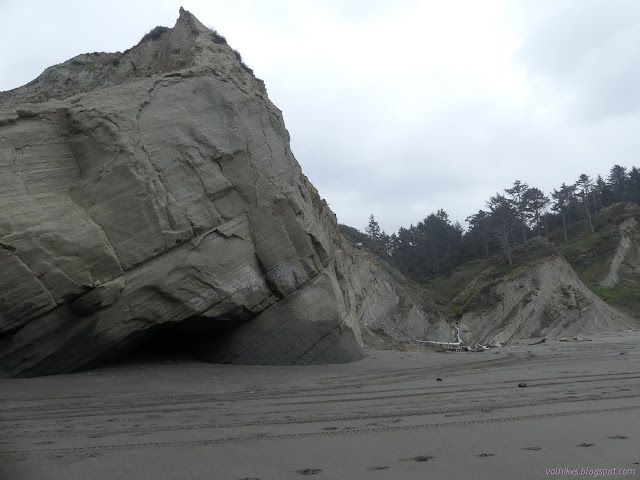 tilted rock layers and a cave