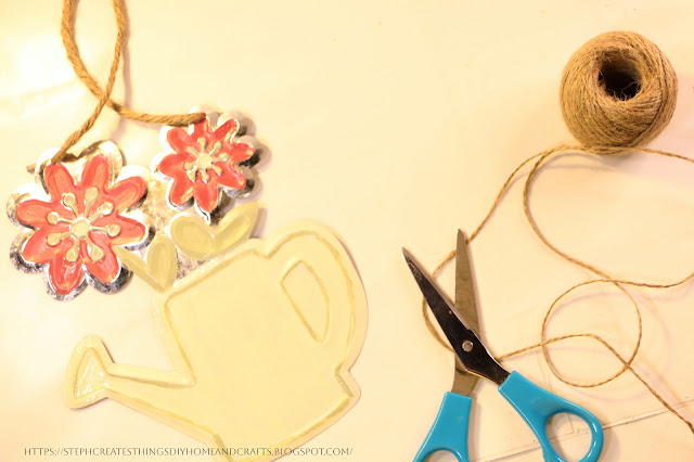 Galvanized flower decor, scissors and twine on a table