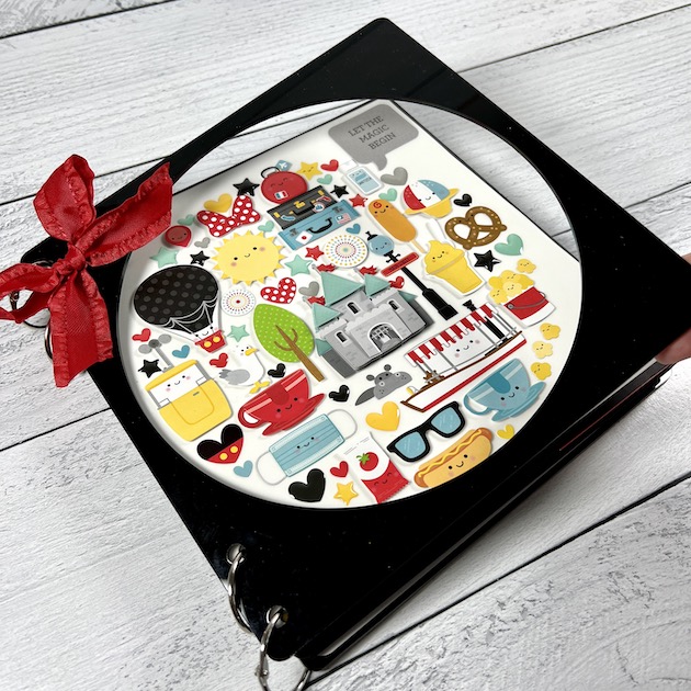 Disney themed scrapbook album with circle window and colorful stickers
