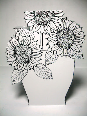Color the front and stamp, then color (I used the Peerless watercolors again) and cut more blossoms