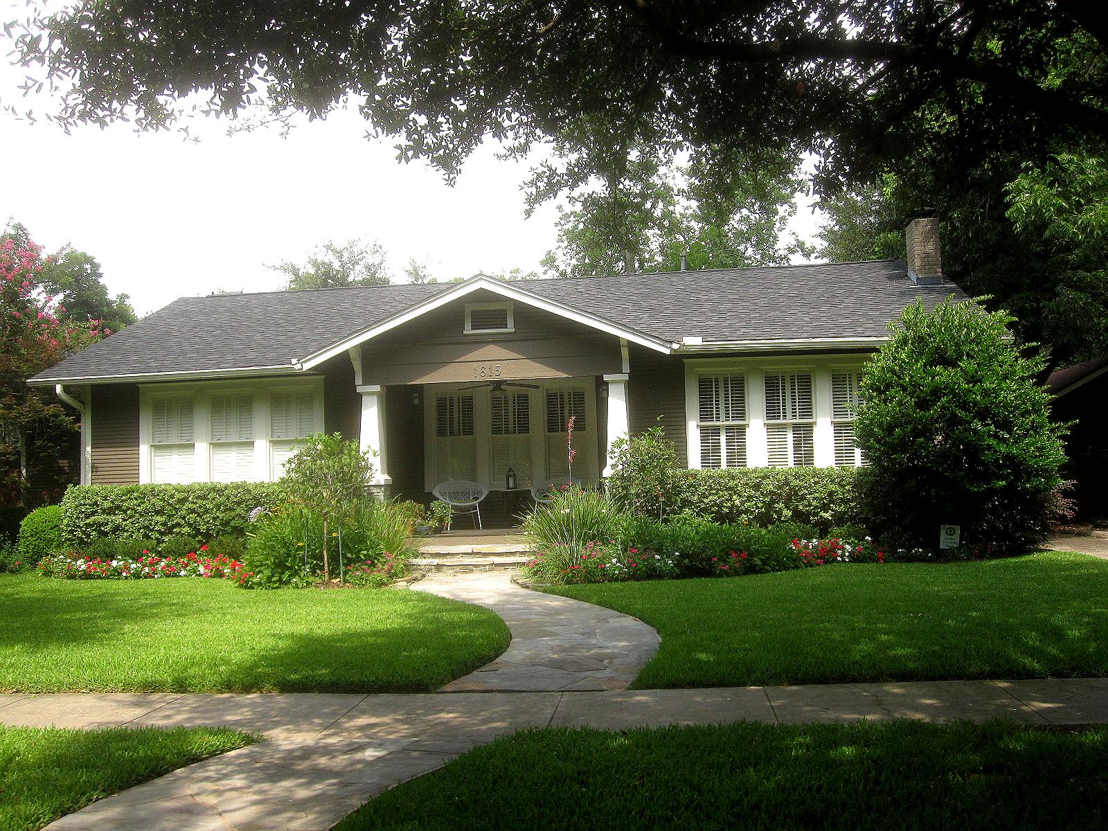 The well-trimmed hedges and lawn compliment this cute bungalow. The 