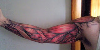 3d tattoo creating the illusion that the skin is ripped and the arm's muscles are visible