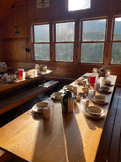 morning light on tables laid out for breakfast at AMC Greenleaf hut