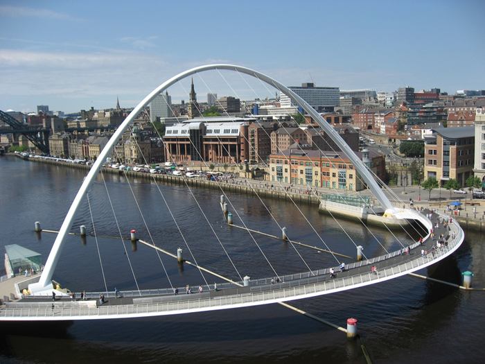 The Gateshead Millennium Bridge is a pedestrian and cyclist tilt bridge spanning the River Tyne in England between Gateshead's Quays arts quarter on the south bank, and the Quayside of Newcastle upon Tyne on the north bank. The award-winning structure was conceived and designed by architects Wilkinson Eyre and structural engineers Gifford. The bridge is sometimes referred to as the 'Blinking Eye Bridge' or the 'Winking Eye Bridge' due to its shape and its tilting method. In terms of height, the Gateshead Millennium Bridge is slightly shorter than the neighbouring Tyne Bridge, and stands as the sixteenth tallest structure in the city.