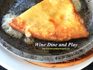 The saganaki starter dish of cooked cheese hit with alcohol then lit on fire for an Opa experience at Costas Greek restaurant in Tarpon Springs, Florida