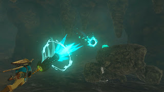 Link using some sort of hammer cannon shooting a glowing orb at a Talus