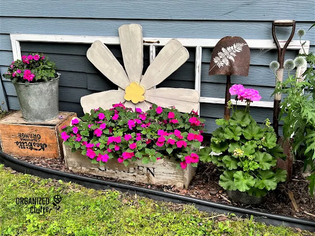 Photo of a junk garden vignette in July.