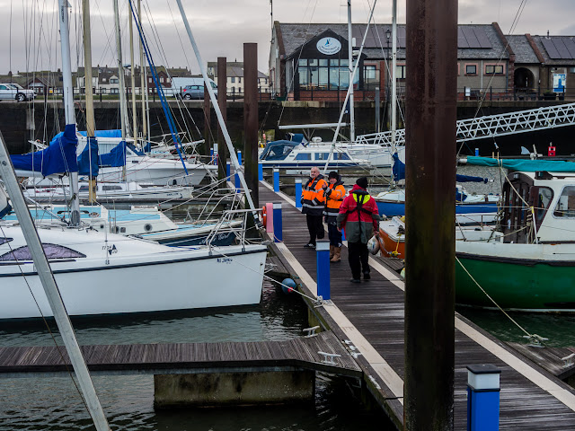 Photo of marina staff checking the boats and pontoons after the storm