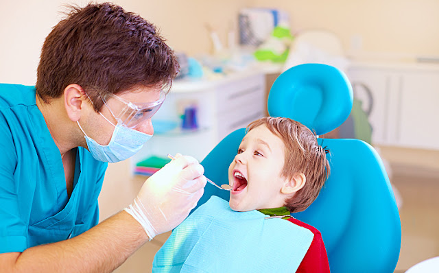 Small Kid Visiting A Dental Specialist