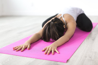 A woman doing yoga on yoga mattress. Healthy Lifestyle