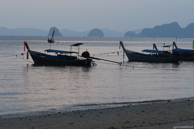 Long tail boats at Klong Muang Beach with the Hong Islands in the background