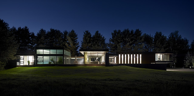 Picture of modern Clearview Residence on the small hill surrounded by the trees as seen at night