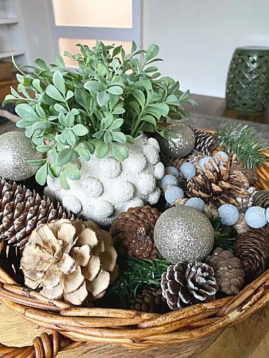 basket of pinecones, beads, and sparkly ornaments