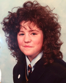 A school photo of Nicky Bond. She has a massive perm.