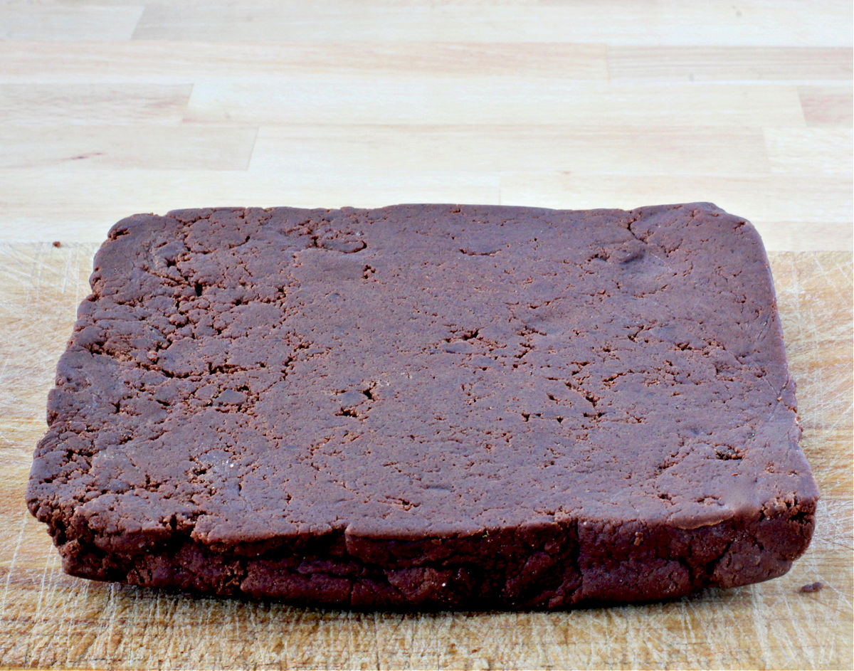 Chocolate Sables Dough on a cutting board.