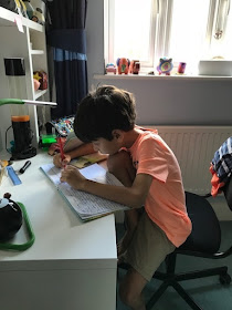 Small boy writing at his desk