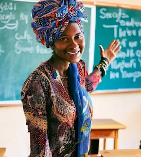 teacher in a headwrap in a classroom in kenya