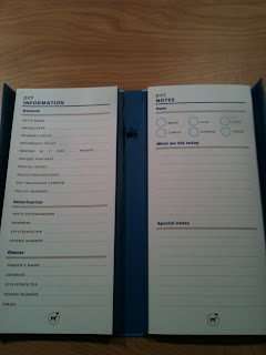 a book about the size of a shopping list pad, with spaces to write your pets information