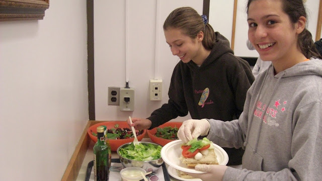 Two kids make salads