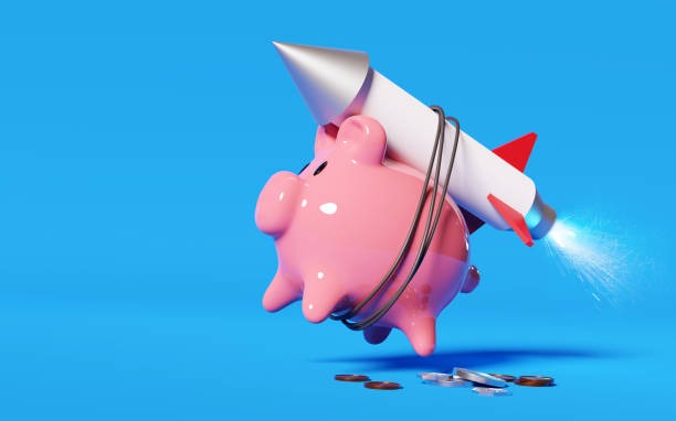 A pig bank, strapped to a rocket.