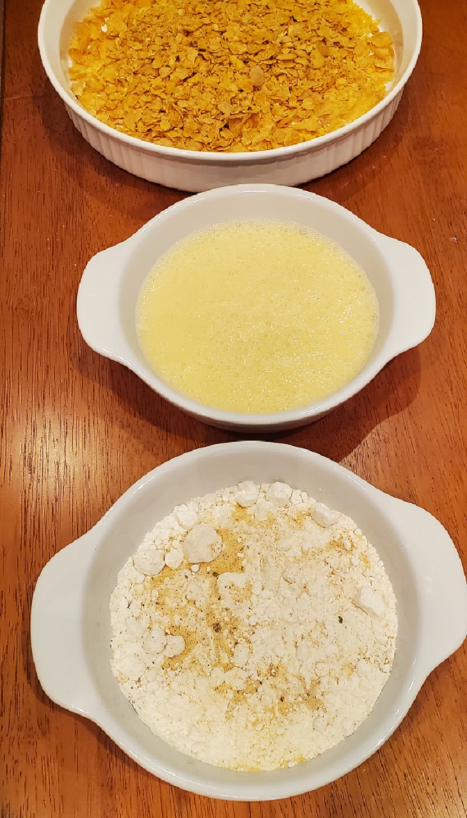 flour, eggs beaten and cornflakes crushed for coating chicken