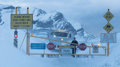 Severe weather signs and road closures in a snowstorm from the movie Cold Pursuit