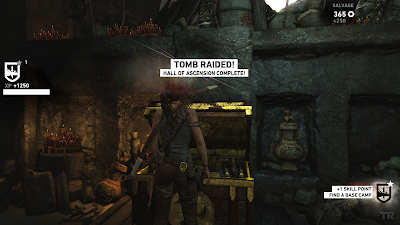 Lara has penetrated the depths of a tomb. The legend "Tomb Raided" is displayed in bold.