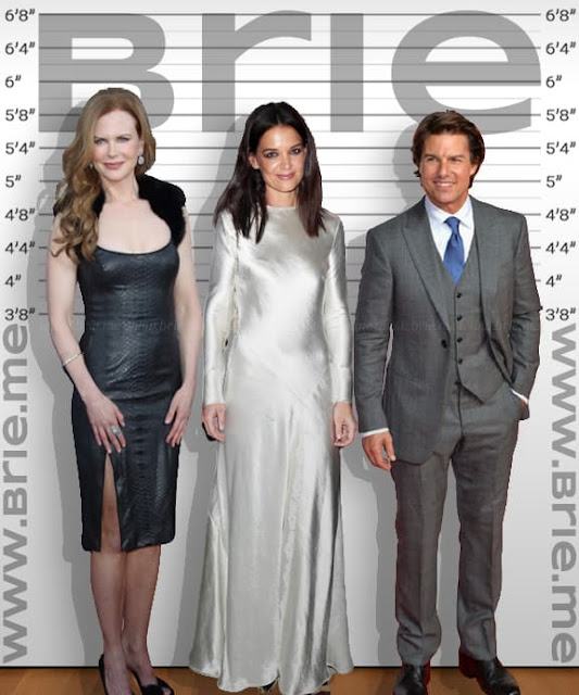 Katie Holmes standing with Nicole Kidman and Tom Cruise