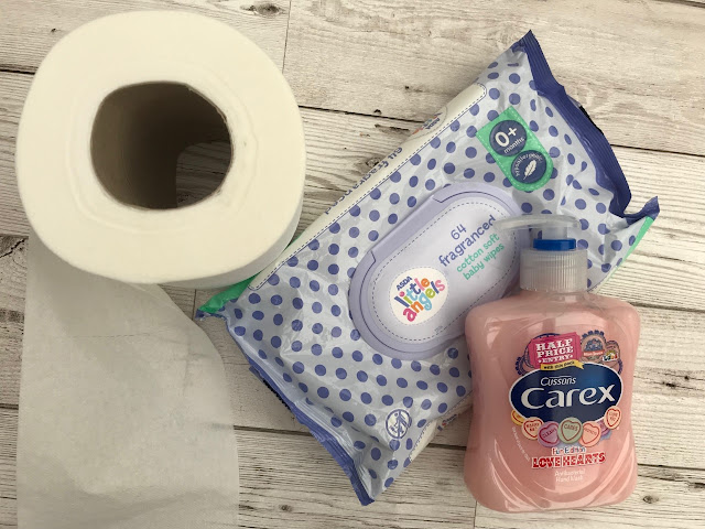 A photo of a toilet roll, wet wipes and handwash