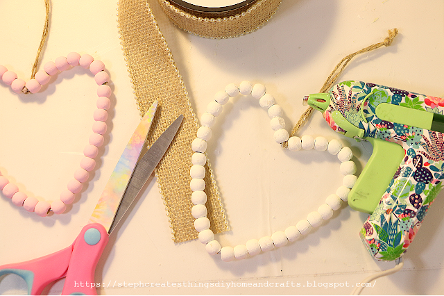 Beaded hearts, ribbon, scissors and hot glue