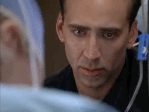 Gif from ‘City of Angels’: Maggie looks at Seth in the emergency room while trying to save Susan.