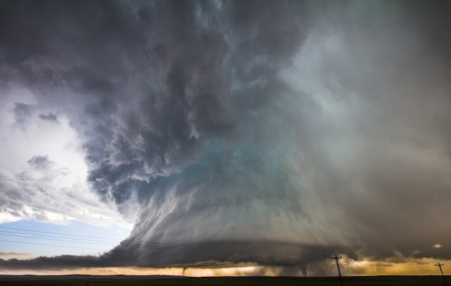 Massive storm clouds and powerful twin tornadoes