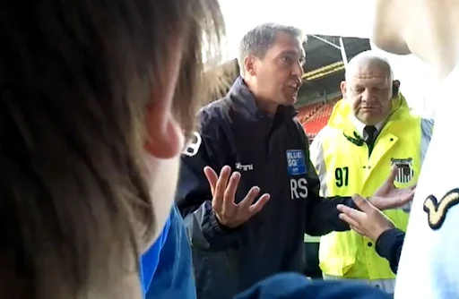 Grimsby manager Rob Scott confronts angry supporters after a league match against Darlington