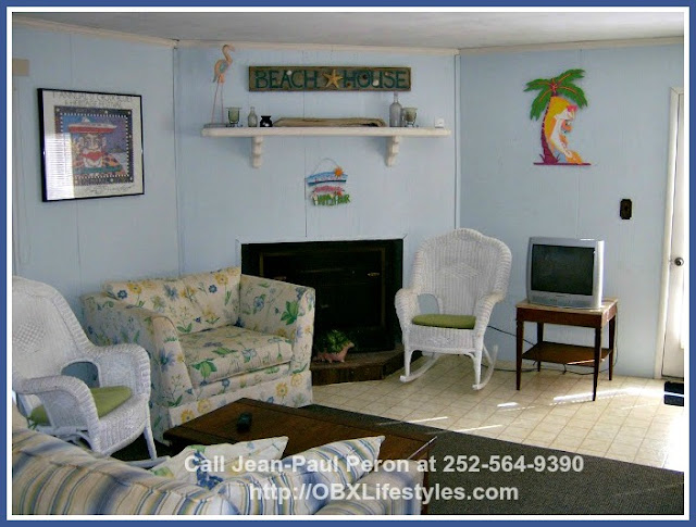 The wood burning fireplace in the living room of this rustic beach cottage for sale on the Outer Banks NC will keep you and your family warm on cold winter nights.