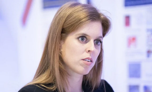 Princess Beatrice wore a new black tiered midi dress by Topshop, and black jacket. British Skin Foundation