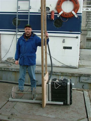 Hydrovolts founder Burt Hamner with Flipwing turbine and test equipment