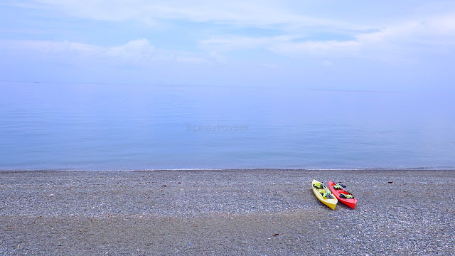 beautiful beach panorama with two (yello and red) kayaks on the beach at Kuting Reef Resort and Spa in Macrohon Southern Leyte