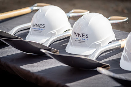 Hard hats and shovels on table for groundbreaking of Innes Redevelopment